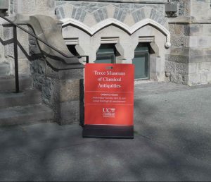 Red sandwich board sign which is placed outisde the building whenever the museum is open.