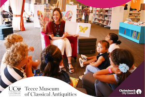 Photograph of librarian ready a story to children in a library.