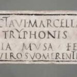 Image of a Roman Funerary inscription with black text on white marble slab. 