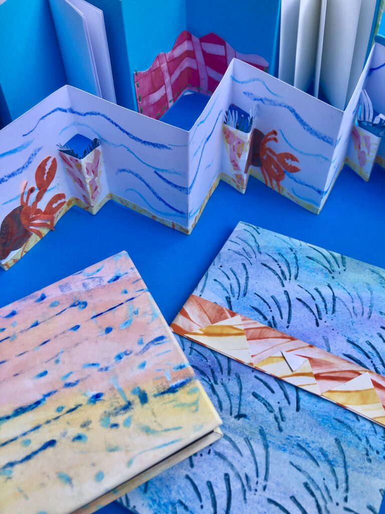 Collection of blue paper craft booklets and papers.